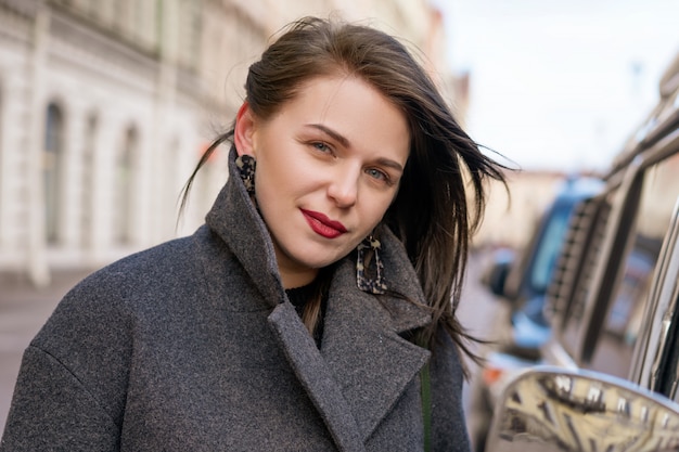 Portrait of happy woman in coat