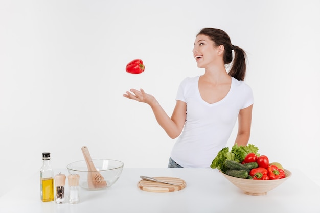 Portrait of happy woman cooking with vegetables