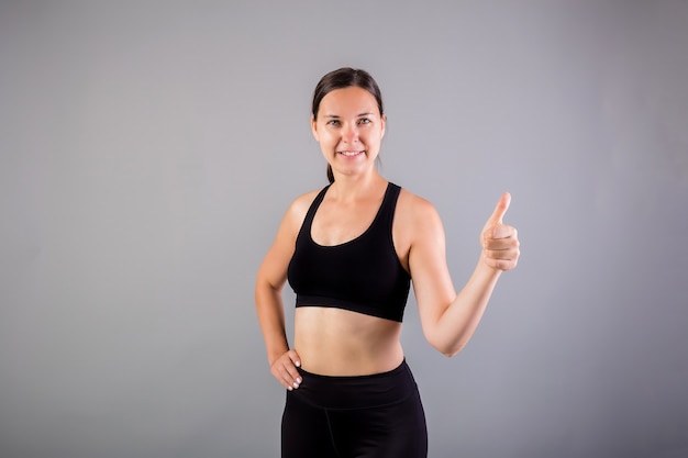 Portrait of happy woman showing thumbs-up