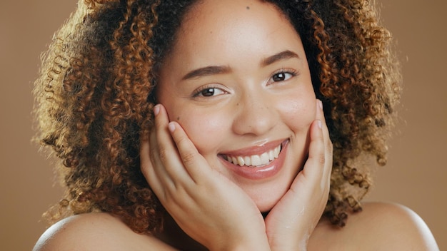 Photo portrait of happy woman smile or healthy skin for wellness in studio with beauty facial results or glow dermatology natural or confident biracial model with skincare cosmetics on brown background