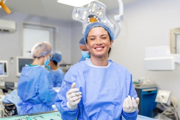 Portrait of happy woman surgeon standing in operating room ready to work on a patient Female medical worker in surgical uniform in operation theater