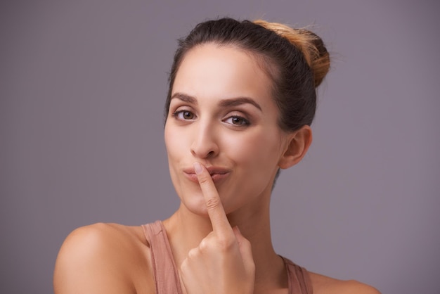 Photo portrait of happy woman touching lips or silence for secret silence or privacy on grey background mouth natural face or confident model isolated in studio with beauty for skincare or wellness