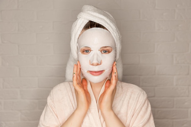 Photo portrait of happy woman using cosmetic for facial treatment