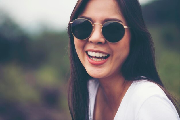 Portrait of happy woman wearing sunglasses