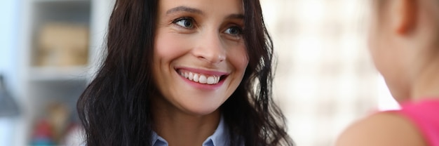 Portrait of happy woman with funny pink piggy bank.