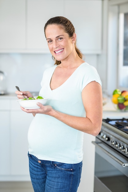 Portrait of happy woman with salad