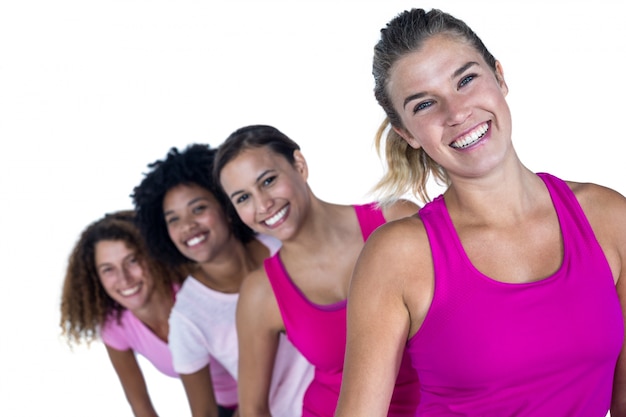 Portrait of happy women standing in row 