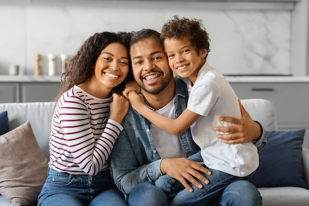 Portrait of happy young african american family of three with little son