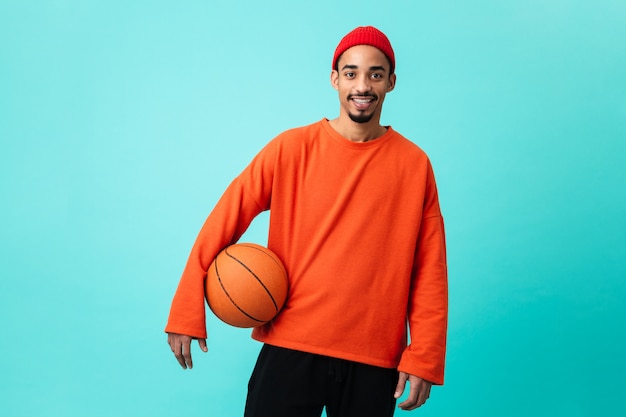 Portrait of a happy young afro american man in hat