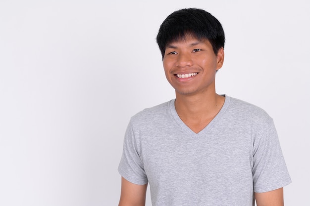 Portrait of happy young Asian man posing