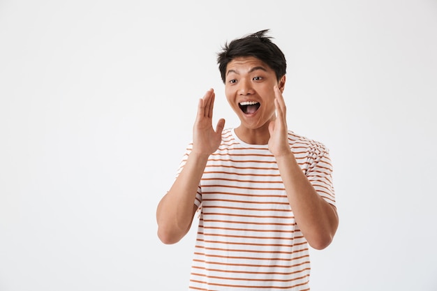 Portrait of a happy young asian man shouting loud