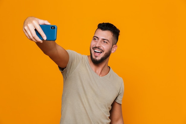 Portrait of a happy young bearded man in t-shirt