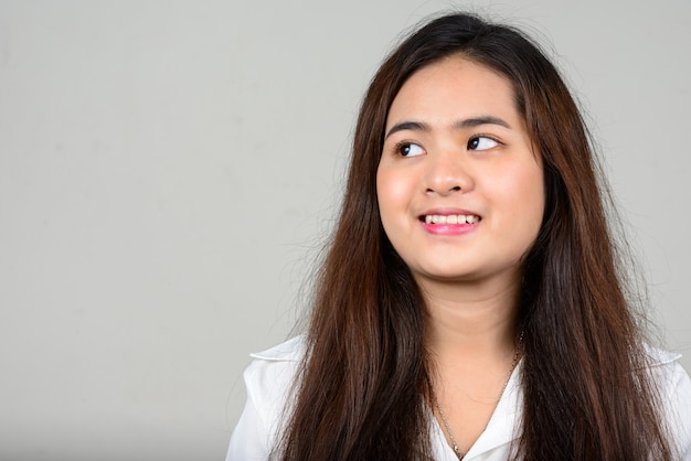 Portrait of happy young beautiful Asian woman