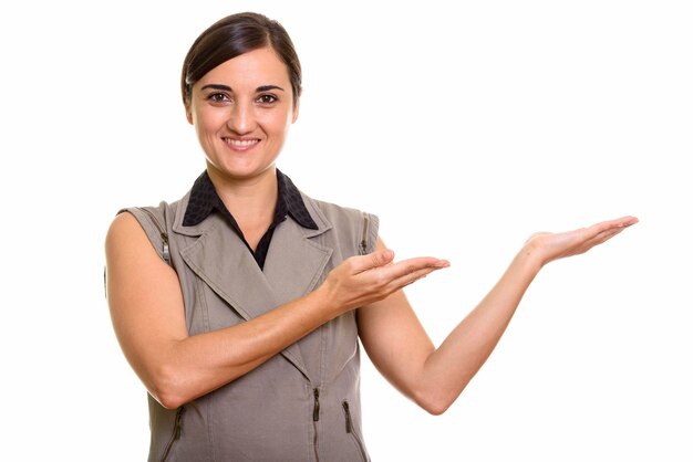 Portrait of happy young beautiful businesswoman showing something