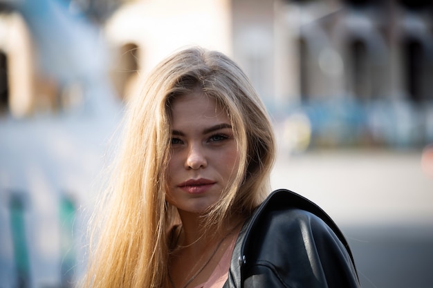 Portrait of happy young blonde woman in sunglasses with long hair