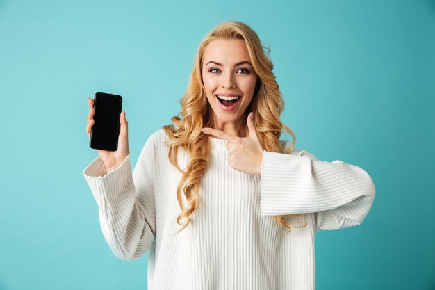 Portrait of a happy young blonde woman in sweater