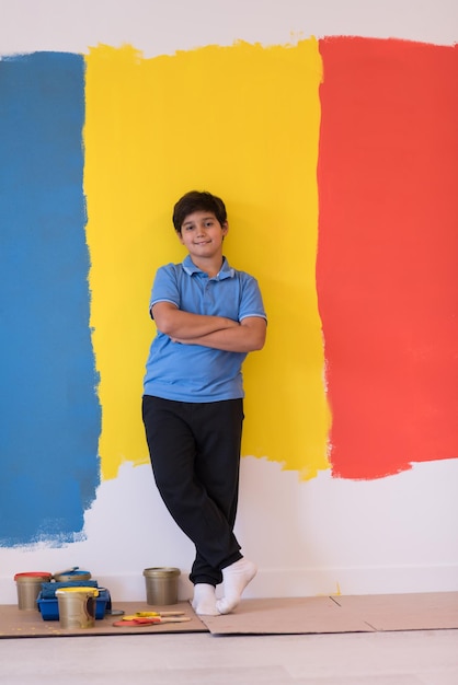 Portrait of a happy young boy in front of colored background