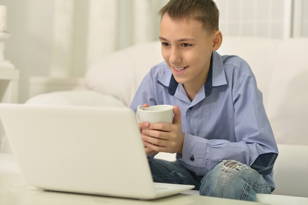 Portrait of a happy Young boy and  laptop computer