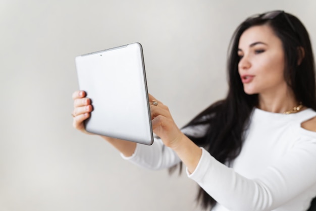 Portrait of a happy young business woman using a tablet working outside the office Modern technologies and business