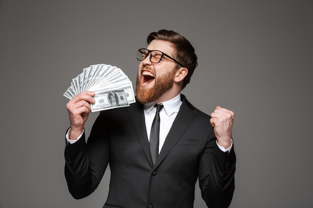 Portrait of a happy young businessman dressed in suit