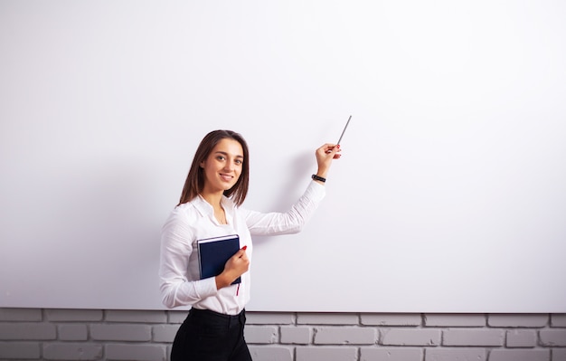 Portrait Of Happy Young Businesswoman woman near on white wall