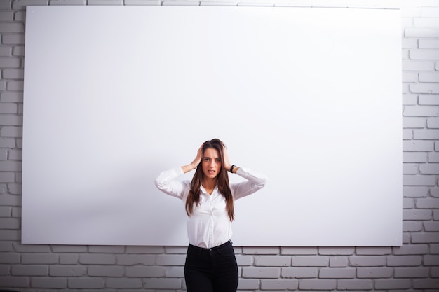 Portrait Of Happy Young Businesswoman woman near on white wall