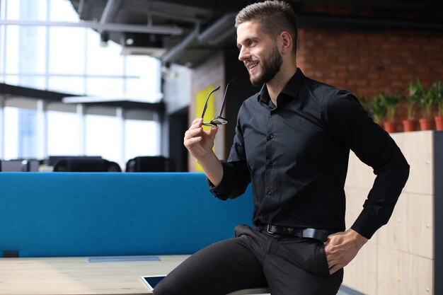 Portrait of a happy young casual businessman at office.