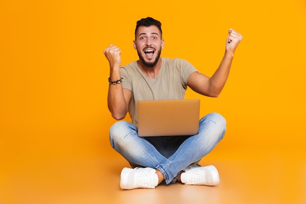 Portrait of a happy young casual man sitting