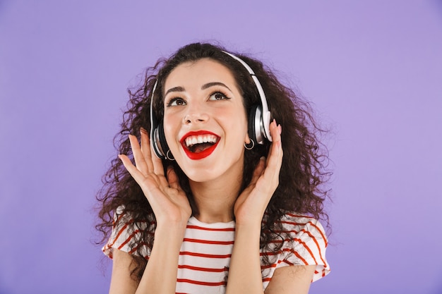Portrait of a happy young casual woman listening to music