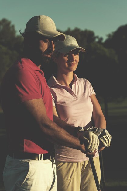 portrait of happy young  couple on golf course