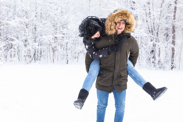 Portrait of happy young couple in winter park