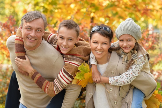 Portrait of happy young family in autumn park