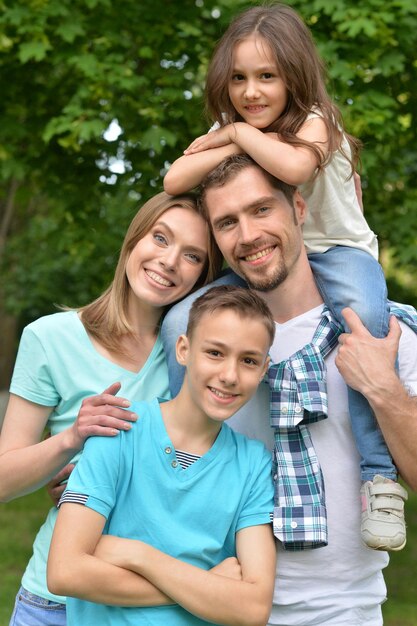 Портрет счастливой молодой семьи в летнем парке