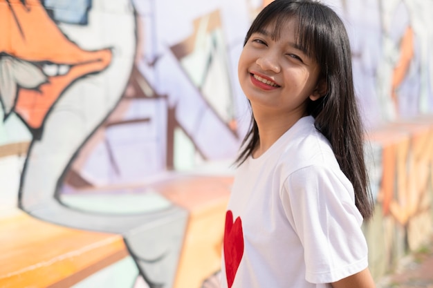 Photo portrait happy young girl on colorful background.