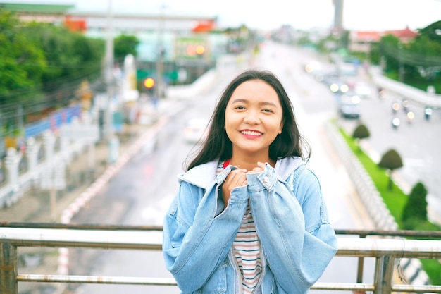 Portrait happy young girl with beautiful landscape view at Roiet Thailand.