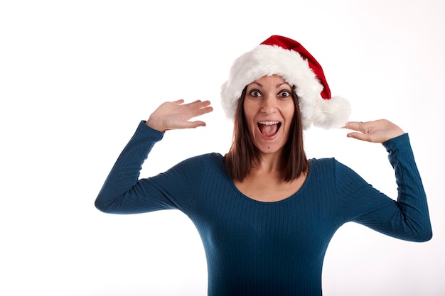 Portrait of a happy young girl with a Santa Claus hat on a white background