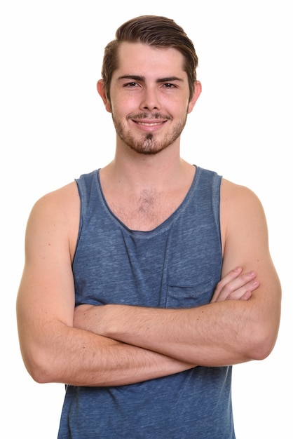 Portrait of happy young handsome bearded man ready for gym