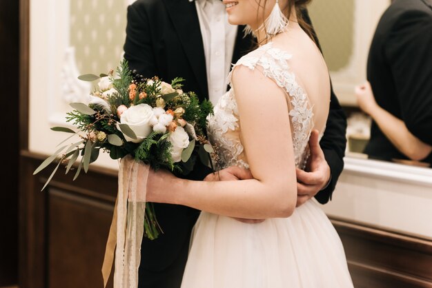 Portrait of happy young lovers of the bride and groom in a luxurious interior. Wedding day