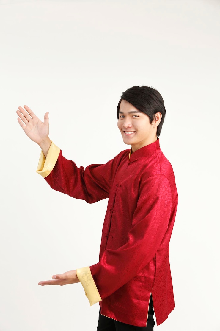 Photo portrait of happy young man gesturing while standing against white background