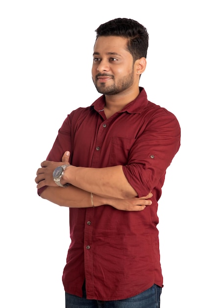 Portrait of a happy young man posing with arms crossed or hands folded on a white background