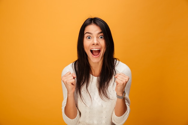 Portrait of a happy young woman celebrating