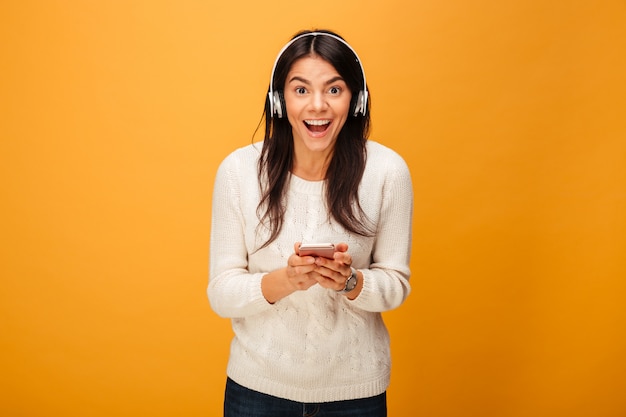 Portrait of a happy young woman listening to music