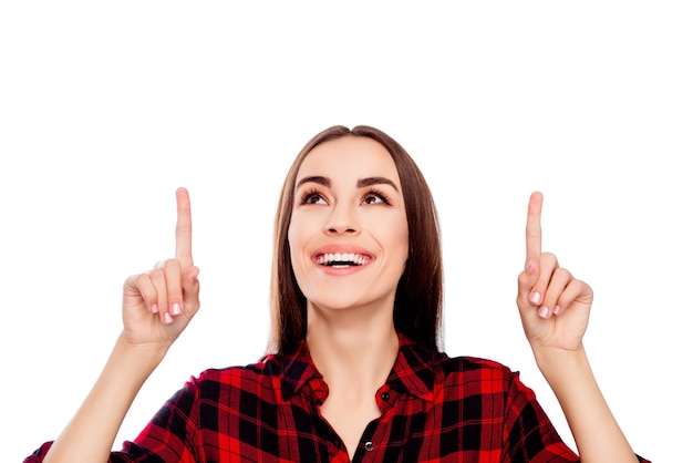 Portrait of happy young woman showing up direction