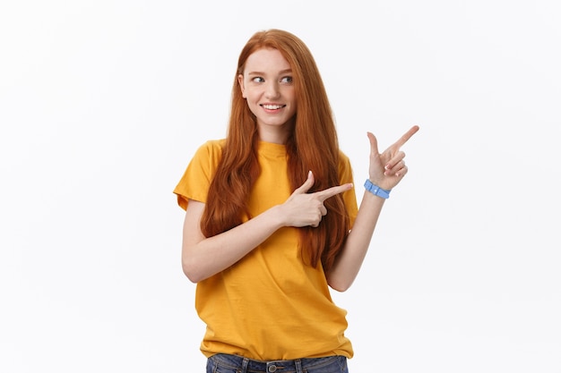 Portrait of happy young woman standing isolated over white wall