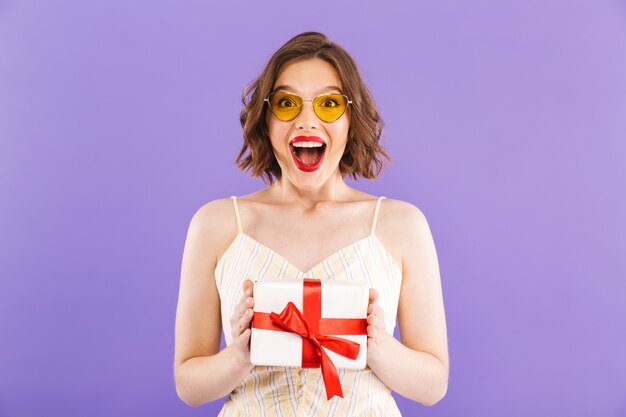 Portrait of a happy young woman in sunglasses