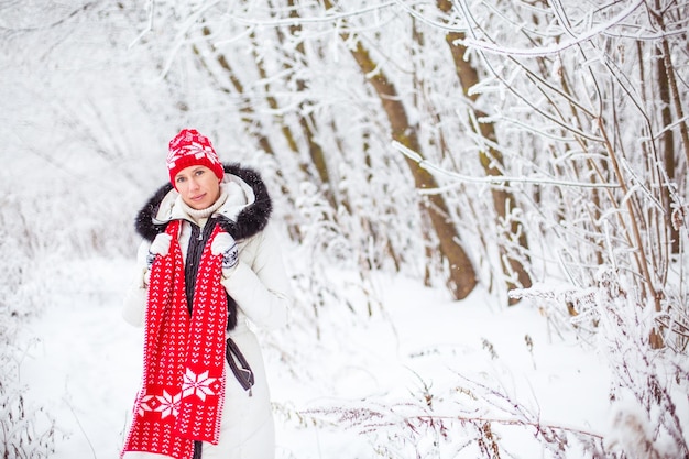 Portrait of happy young woman in winter forest