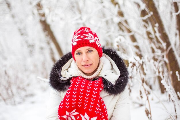 Portrait of happy young woman in winter forest