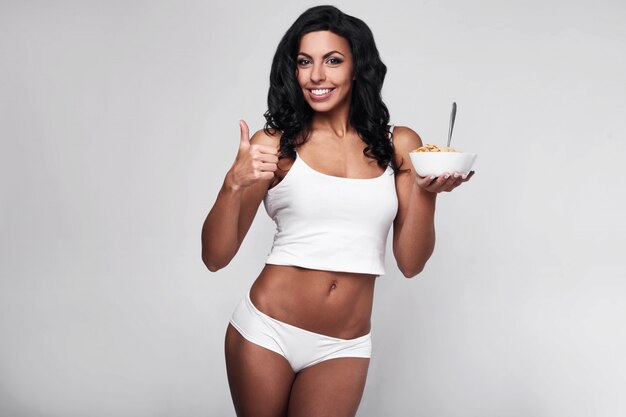 Portrait of healthy fitness woman eating quick breakfast