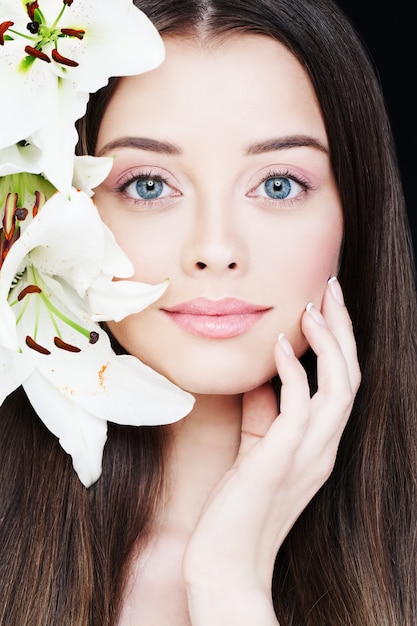 Portrait of Healthy Woman with Lily Flowers