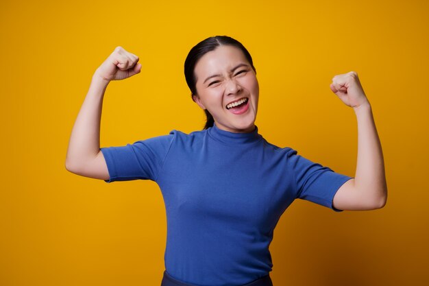 Portrait of a healthy woman over yellow.